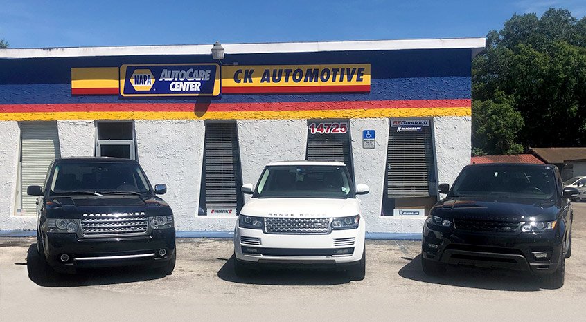 Three customer Range Rovers parked in front of the CK Automotive building