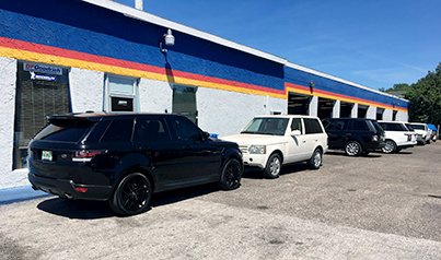A line of Land Rovers waiting along the CK Automotive service bays
